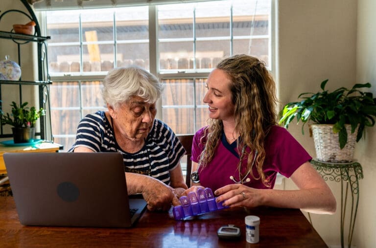 Carer helping sort pills